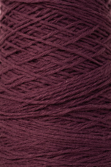 Close up of beetroot coloured tufting yarn