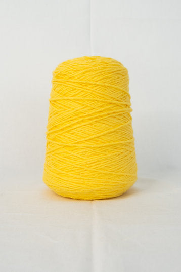 A cone of yellow tufting yarn on a white background.