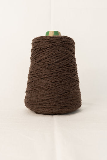 A brown acrylic yarn cone for tufting projects, placed on a white background.