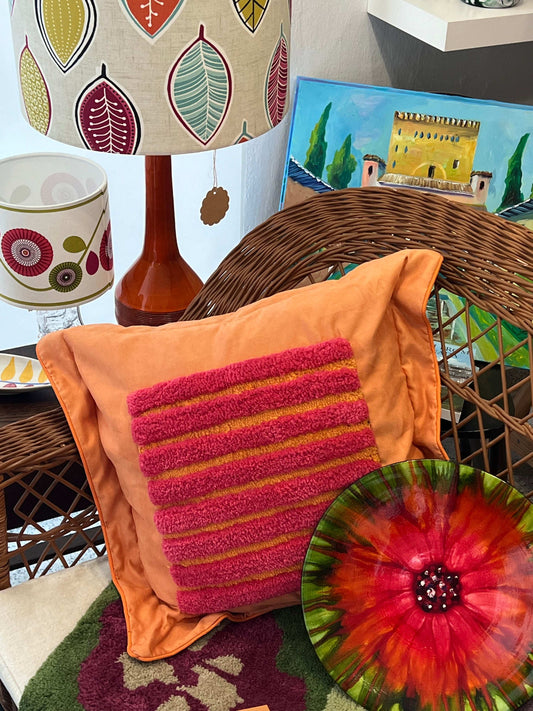 A gift card from Lucas Miles Atelier and Woolly Mammoth Tufting Club, displayed with a decorative lamp and artwork in the background.