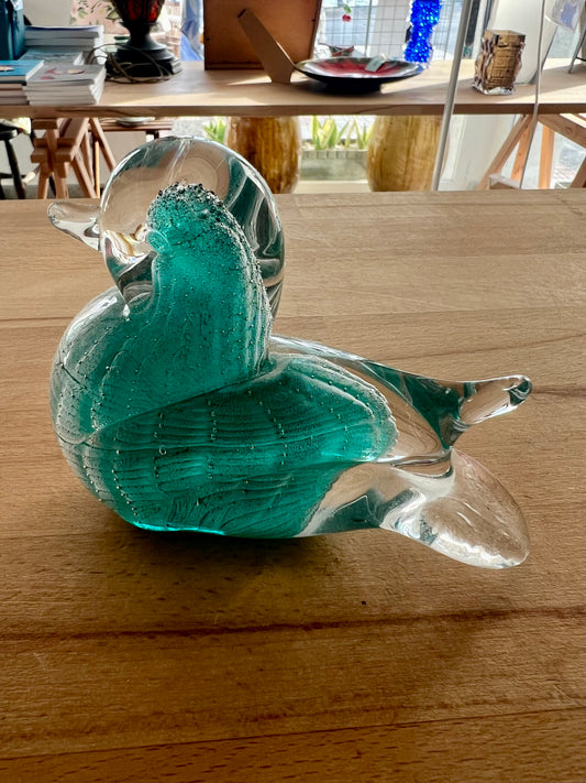 Glass sculpture of a swan on a wooden table