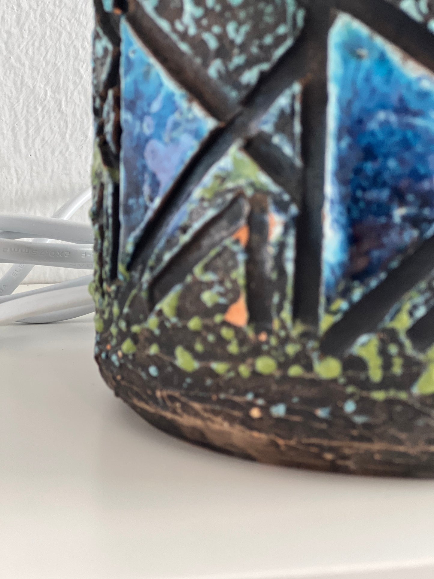 Close up of glaze chip damage of stoneware lamp base