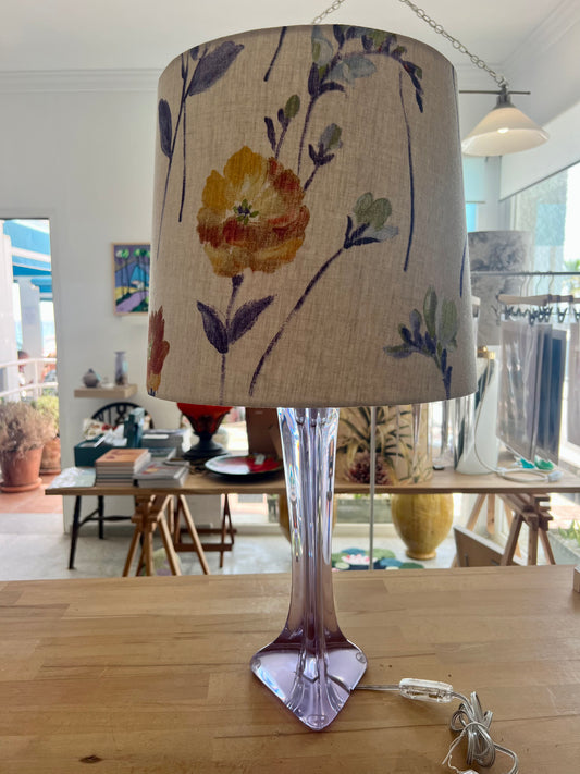 French vintage table lamp with floral-patterned lampshade on a wooden workbench