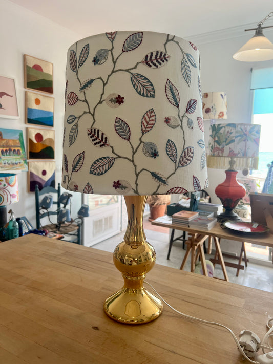 Decorative gold lamp with leaf-patterned embroidered lampshade