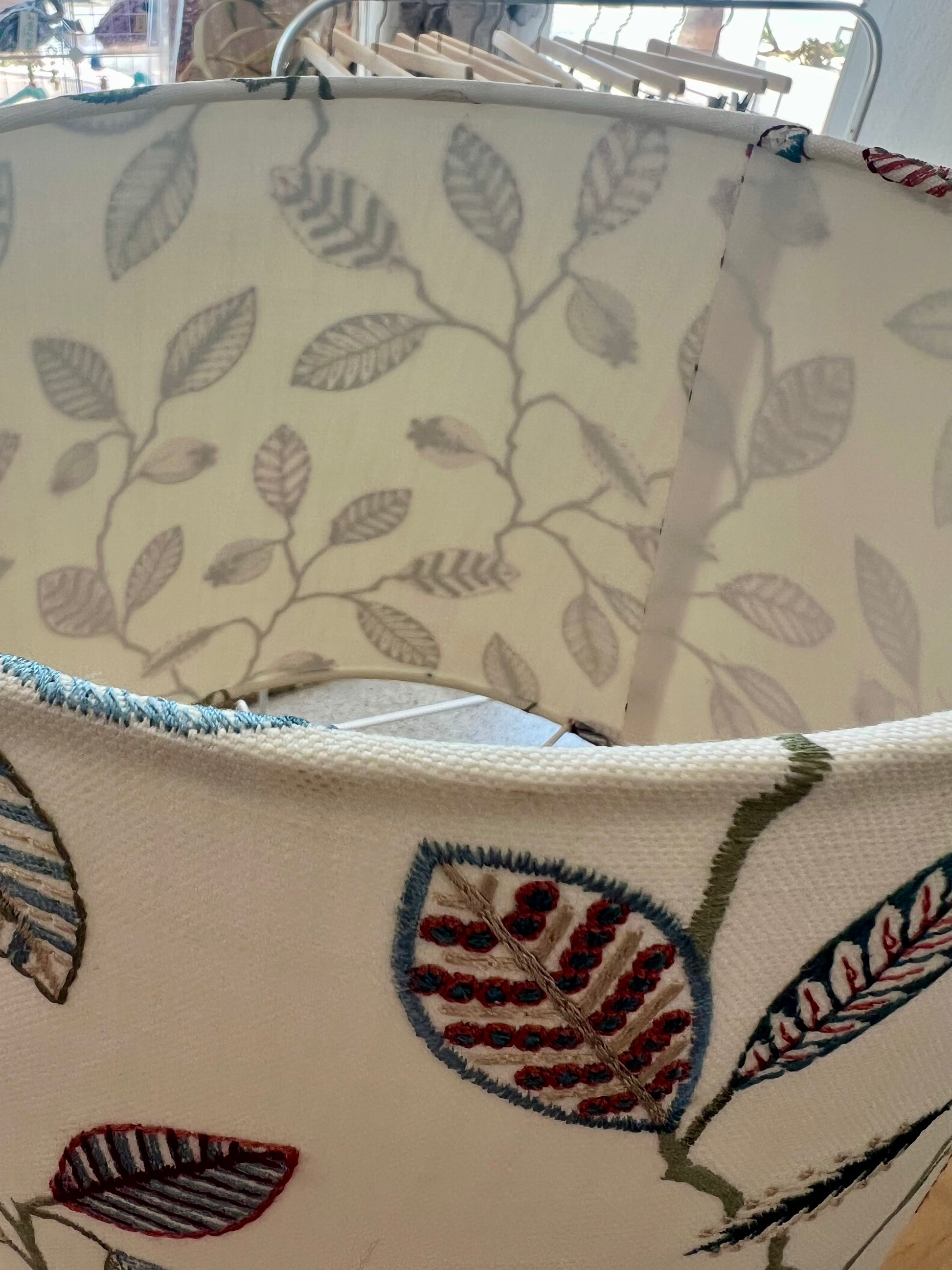 Embroidered lampshade with leaf pattern on a white background with white interior