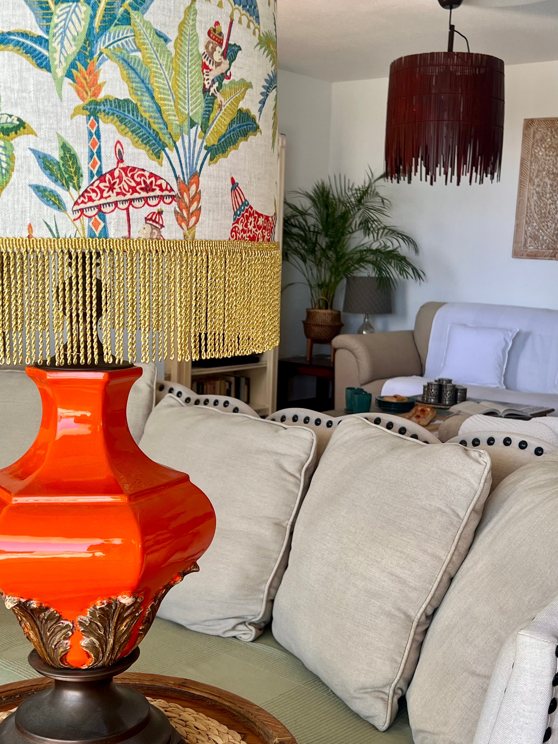 Living room with a colorful lamp, sofa, and decorative wall art.