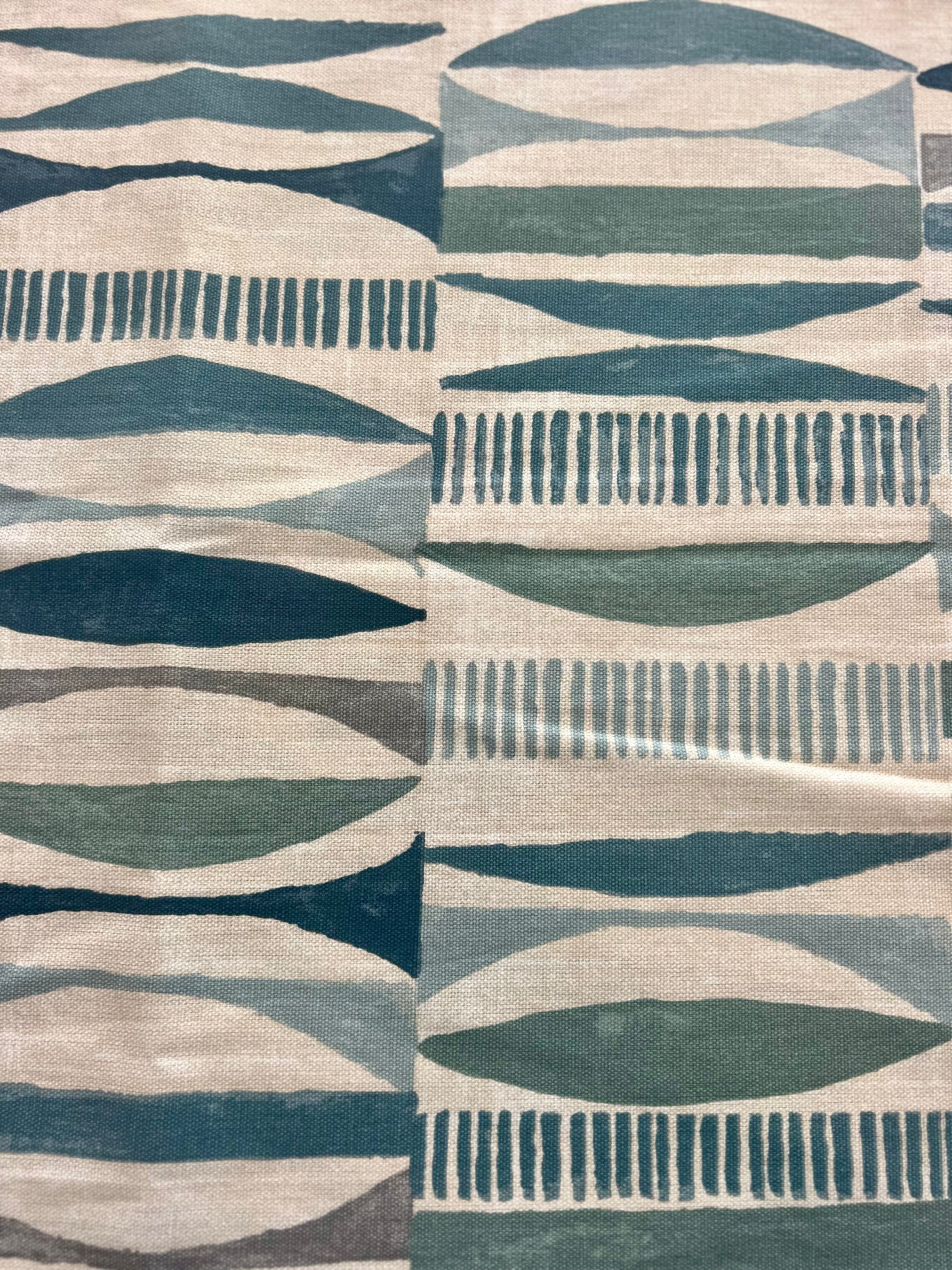 Patterned fabric swatch with geometric design in blue, gray, and beige tones.
