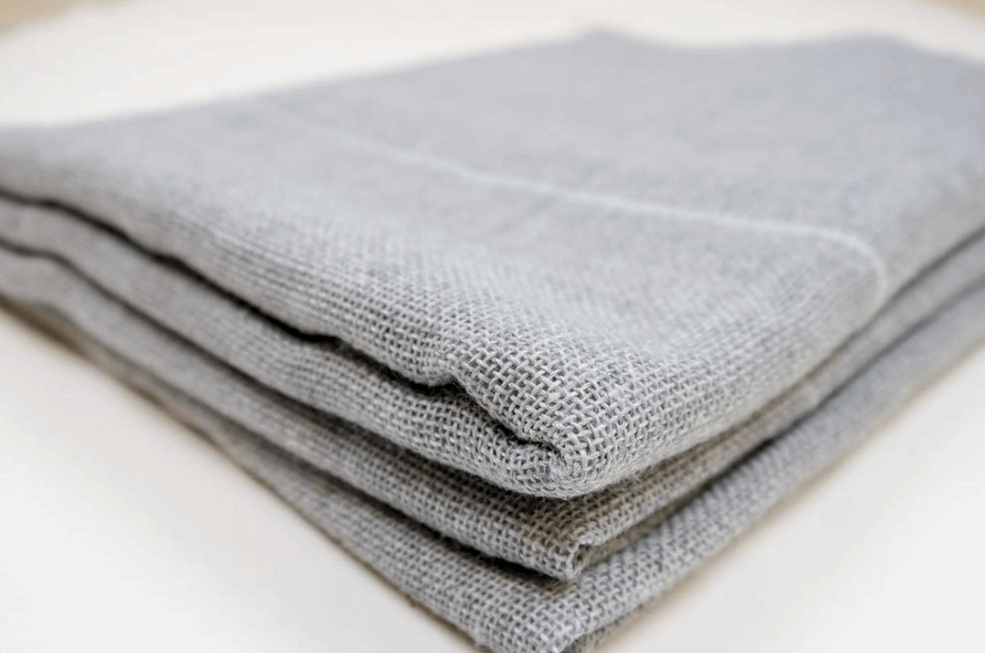 Polyester tufting primary cloth pieces, showing the woven structure and texture.