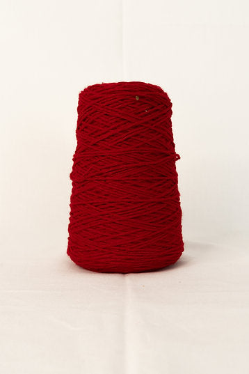 A cone of red tufting yarn placed against a white background.