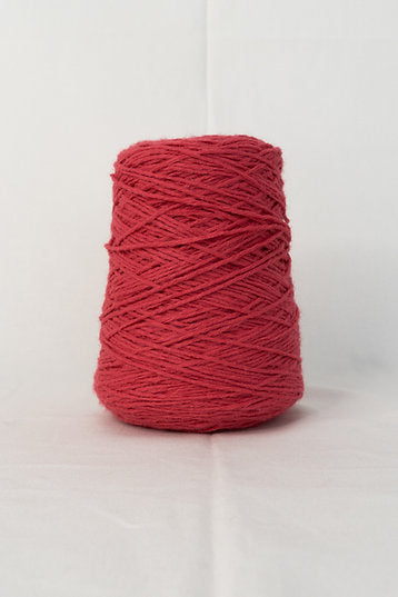 A dark pink cone of acrylic tufting yarn against a white background.