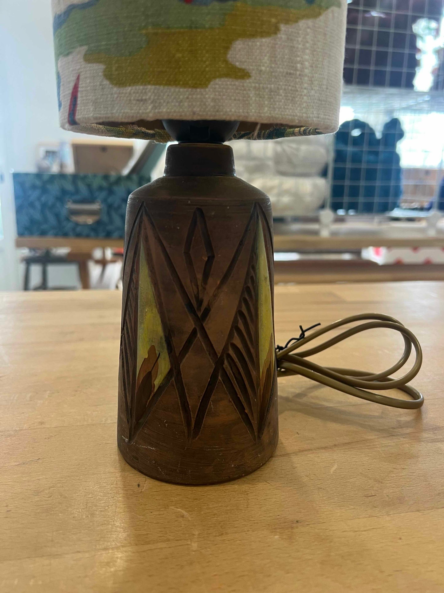 Decorative lamp with geometric design on a wooden surface