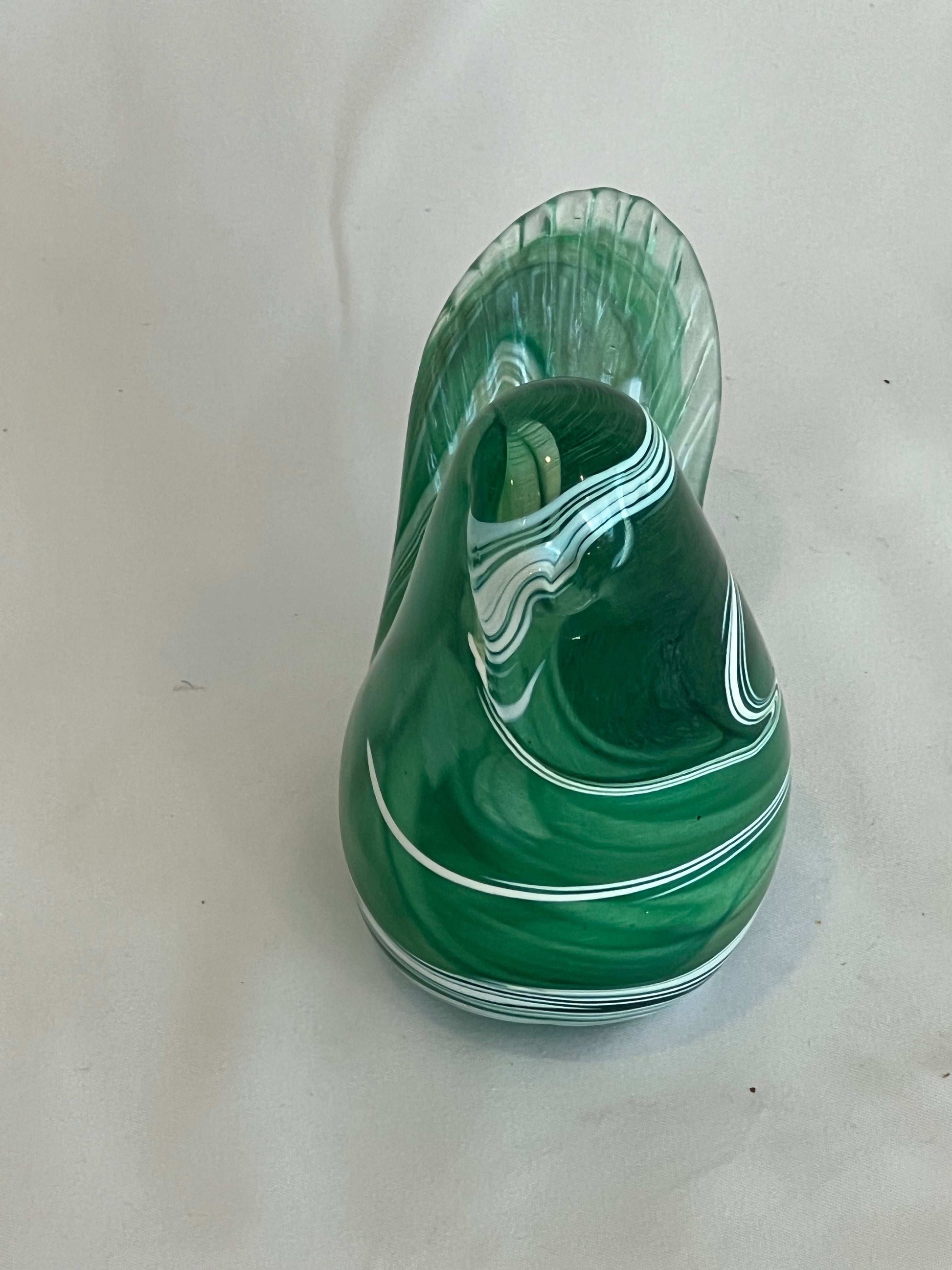 Green and white glass swirl bird on white background