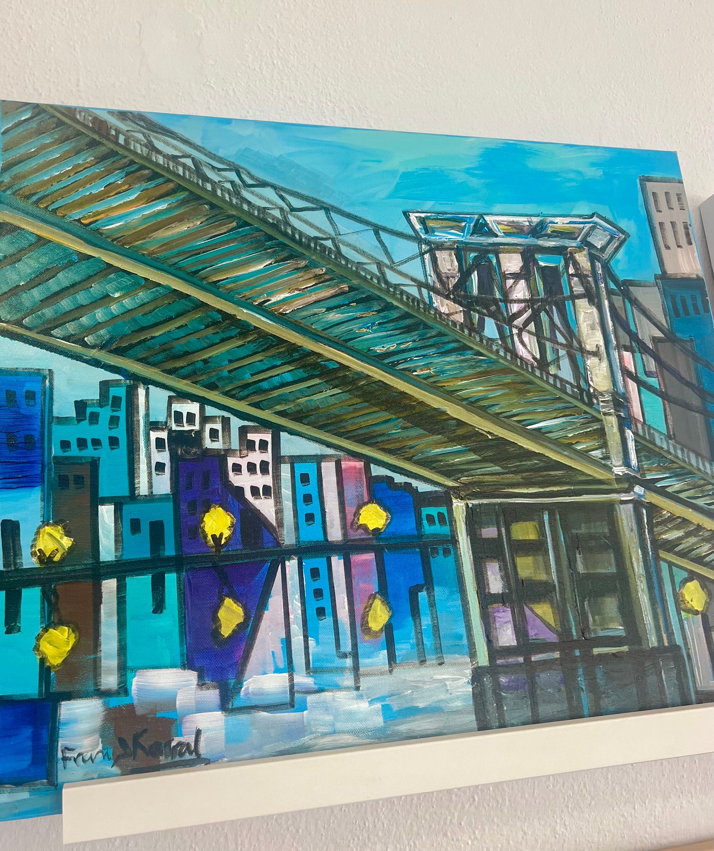 Artistic depiction of a cityscape with a bridge, buildings, and trees on a reflective surface.