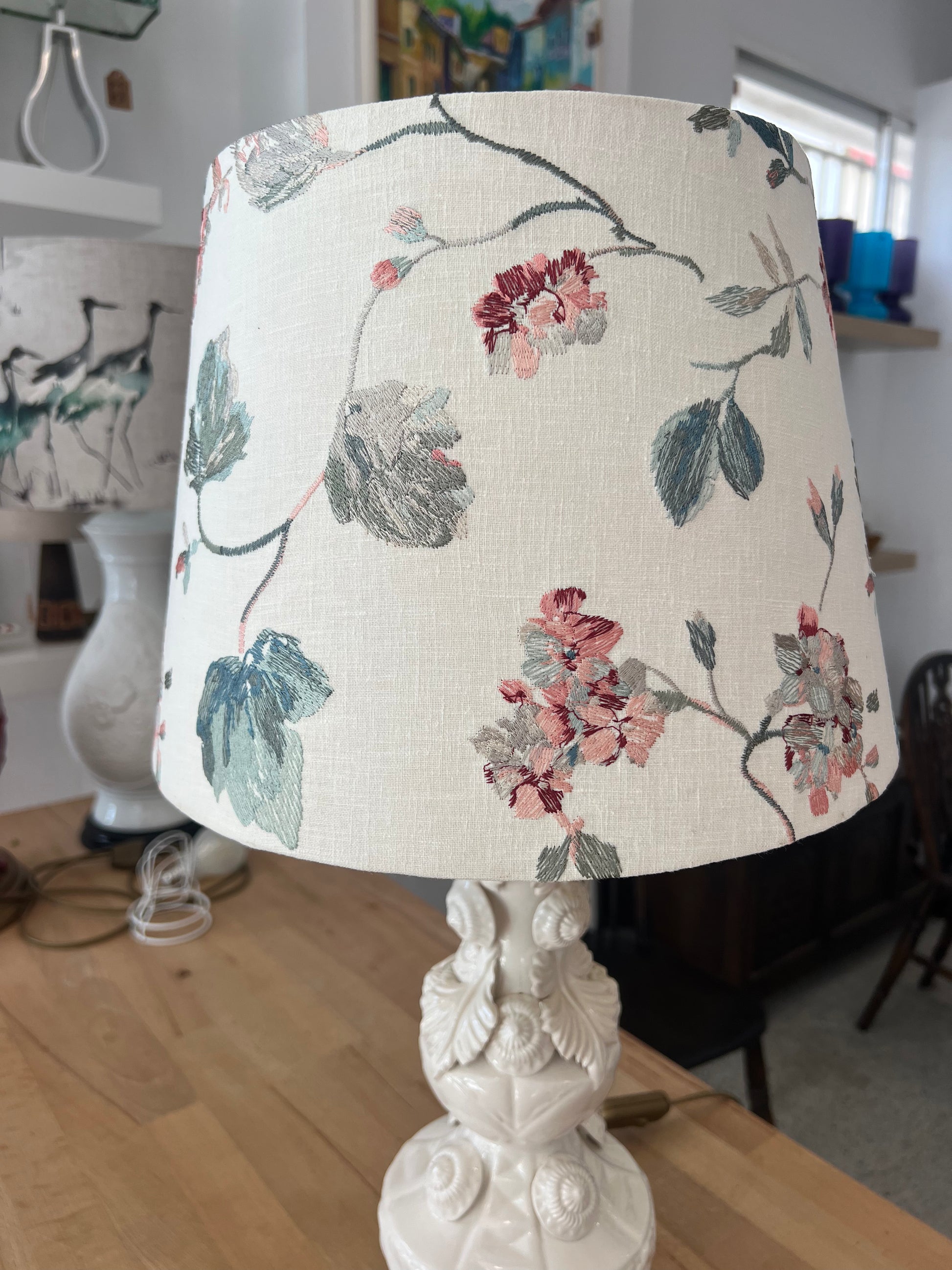 Manises Lamp with floral patterned shade on a wooden surface
