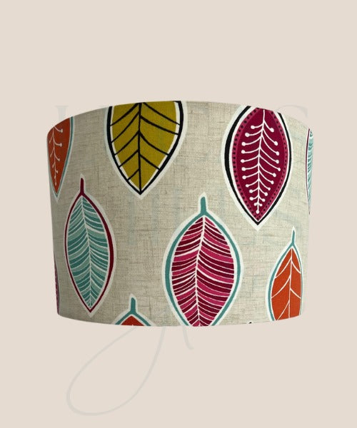 Drum  lampshade with a contemporary leaf pattern in various colors including yellow, red, and blue.