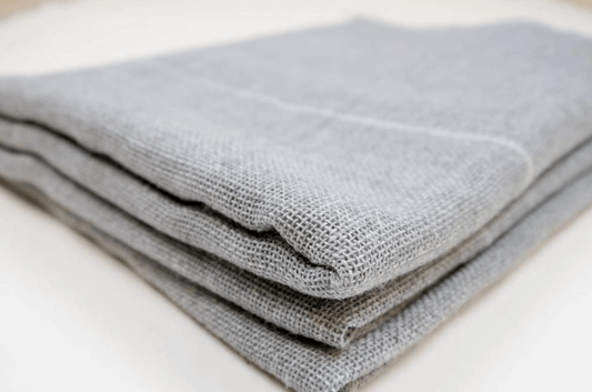 Polyester tufting primary cloth pieces, showing the woven structure and texture.