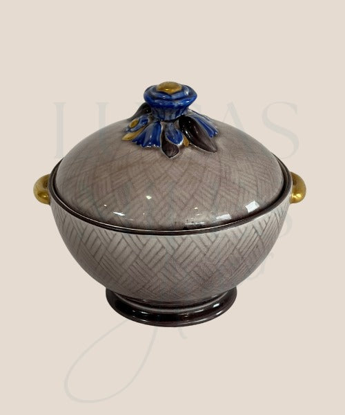 A vintage ceramic sweety jar with gold detailing on the handles and lid, featuring a floral pattern and a crackle glaze.